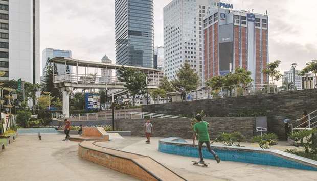 Indonesian teens skateboard at a public park in downtown Jakarta.