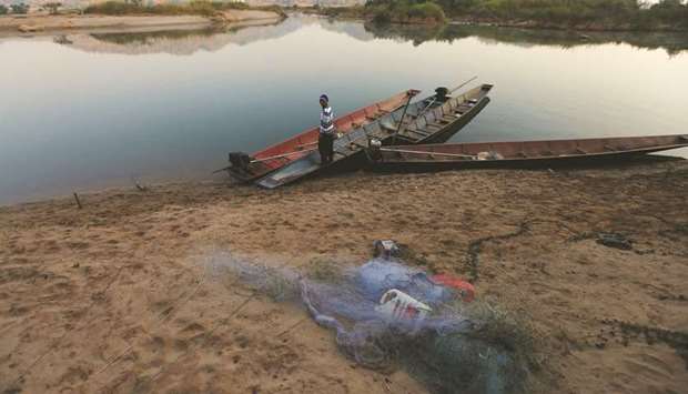 A fisherman is seen on the Mekong river bank outside Nong Khai, Thailand.