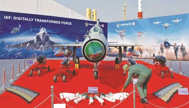 An Indian Air Force officer arranges ammunitions in front of a MiG-21 fighter plane at DefExpo 2020 in Lucknow yesterday.