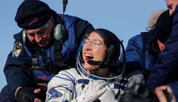 NASA astronaut Christina Koch reacts shortly after landing of the Russian Soyuz MS-13 space capsule in a remote area southeast of Zhezkazgan in the Karaganda region of Kazakhstan