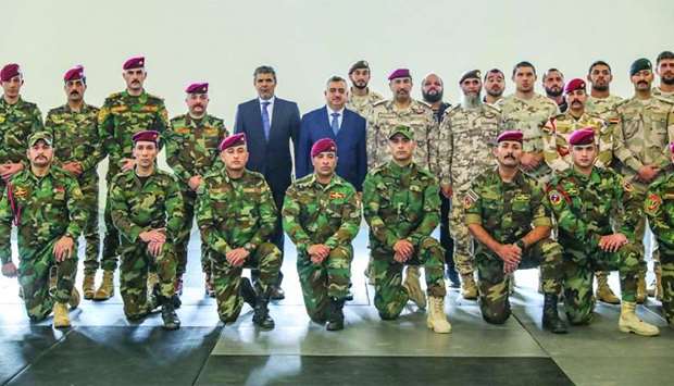 HE Staff Major General Hamad Ahmed al-Nuaimi and HE Omar Ahmed Karim al- Barazanji with the graduate officers.