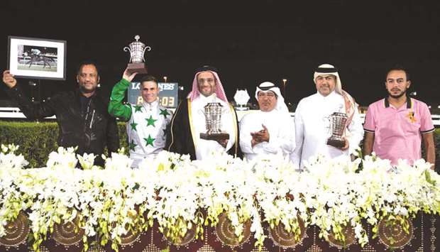 Qatar Racing and Equestrian Club deputy chief steward Abdulla Rashid al-Kubaisi (third from right) with the winners of the Al Wajba Cup after Sheikh Faisal bin Hamad bin Jassim al-Thaniu2019s Topsy Turvy won the feature at Al Rayyan Park yesterday. PICTURES: Juhaim