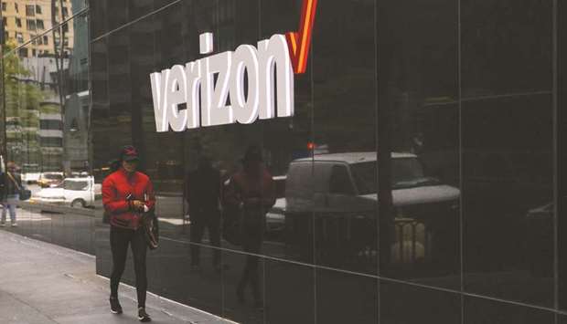 A pedestrian passes in front of Verizon Communications signage outside a store in Chicago. Huawei Technologies has filed two patent infringement lawsuits against Verizon following an apparent failure to agree licensing terms for the use of its intellectual property.