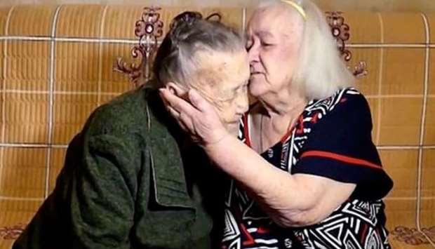 Yulia and Rozalina Kharitonova, now 92 and 94, hugged and kissed as their family members watched in tears.