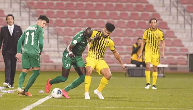 Al Ahliu2019s Mohamed Diame (centre) vies for the ball with El Mehdi Berrahma of Qatar Sports Club during the Amir Cup last 16 match yesterday. PICTURE: Shemeer Rasheed