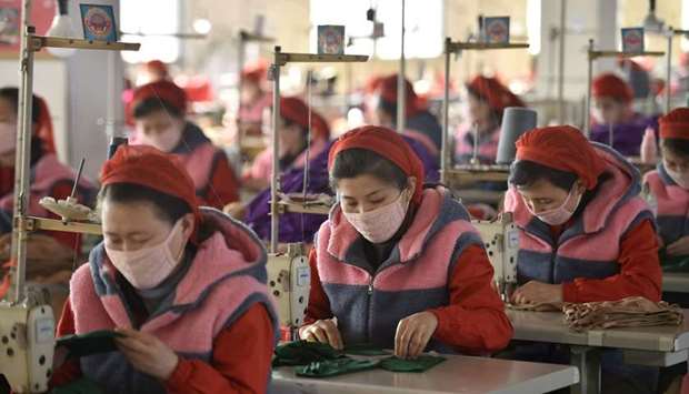Workers of Songyo Knitwear Factory in Pyongyang produce masks for protection against the new coronavirus. AFP