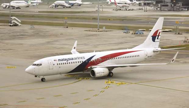 A Malaysia Airlines Boeing 737-800 plane arrives at Kuala Lumpur International Airport. Malaysian business news website Focus Malaysia said yesterday that the countryu2019s sovereign wealth fund has asked it to stop reporting confidential information about the sale of Malaysia Airlines and has threatened it with legal action.