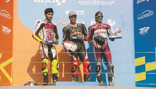 Winner Saeed al-Sulaiti (centre) poses with runner-up Abdulla al-Qubaisi (centre) and third-placed Mishal al-Naimi after the penultimate round of the Qatar Superstock 600 at the Losail International Circuit yesterday.
