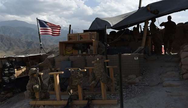 US Army soldiers from NATO look on as US flag flies at a checkpoint during a patrol at the Deh Bala district in the eastern province of Nangarhar Province