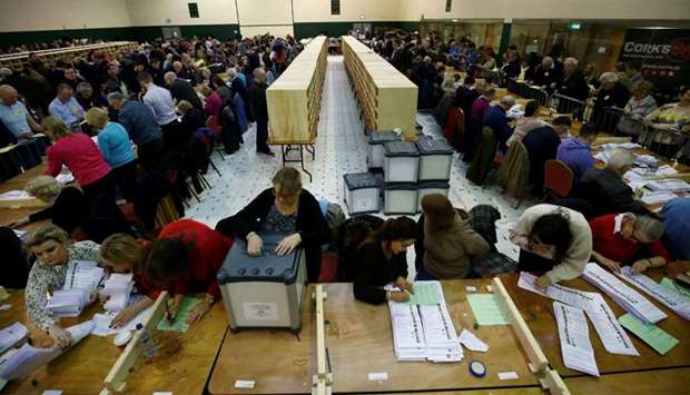Staff members count votes in Ireland's national election, in Cork, Ireland