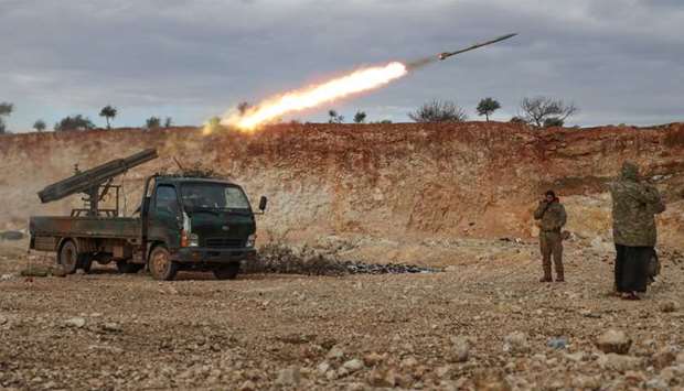Syrian fighters fire a Grad rocket