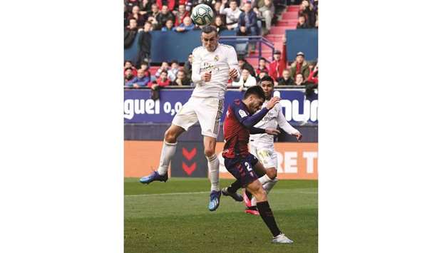Real Madridu2019s Gareth Bale (left) in action with Osasunau2019s Nacho Vidal during the La Liga match against Osasuna in Pamplona, Spain, yesterday. (Reuters)