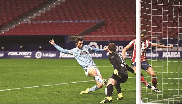 Celta Vigou2019s Argentine forward Facundo Ferreyra (left) scores against Atletico Madrid in the La Liga at the Wanda Metropolitano stadium in Madrid. (AFP)