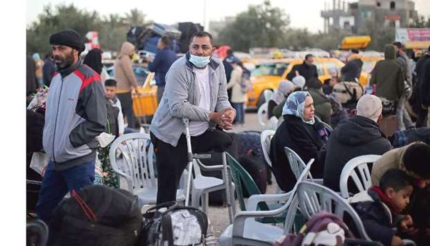 Palestinians wait to leave Rafah border crossing after it was opened by Egyptian authorities, in the southern Gaza Strip, yesterday.