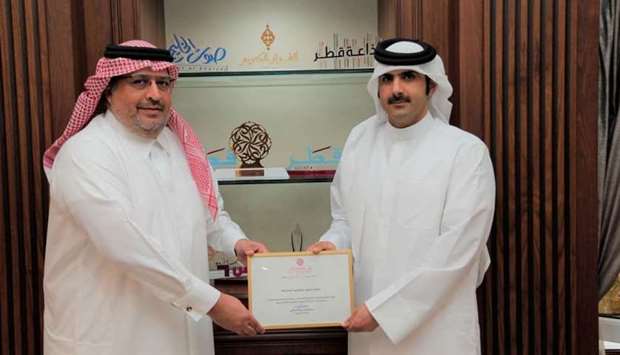 Qatar Media Corporation CEO HE Sheikh Abdulrahman bin Hamad al-Thani honouring Gulf Times editor-in-chief Faisal Abdul Hameed al-Mudahka.