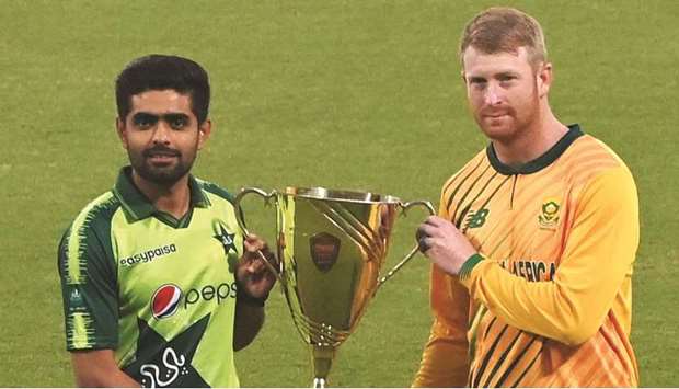 Pakistan captain Babar Azam (left) and South Africa captain Heinrich Klaasen pose with the T20 trophy at the Gaddafi Cricket Stadium in Lahore ahead of the first T20 match. (AFP)