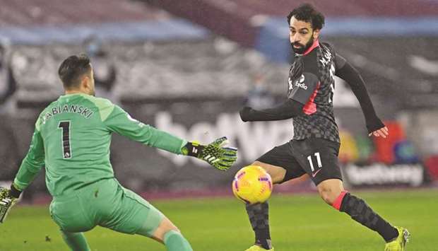 Liverpoolu2019s Mohamed Salah (right) shoots past West Ham Unitedu2019s goalkeeper Lukasz Fabianski to score their second goal during the Premier League match in London, United Kingdom, yesterday. (AFP)