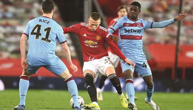 Manchester Unitedu2019s Scottish midfielder Scott McTominay (C) vies with West Ham Unitedu2019s English midfielder Declan Rice (L) during their FA Cup fifth round match at Old Trafford in Manchester.