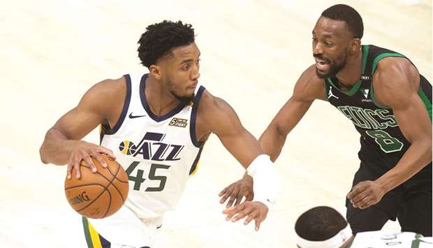 Utah Jazz guard Donovan Mitchell (left) dribbles the ball against Boston Celtics guard Kemba Walker during the second-half of their NBA game at Vivint Smart Home Arena in Los Angeles. (USA TODAY Sports)