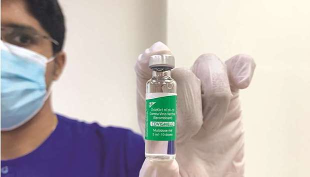 A health worker shows a Covid-19 vaccine in Dubai on February 8. Dubai plans to vaccinate all eligible adults by the end of the year, as the emirate uses a variety of shots and movement restrictions to contain the coronavirus.
