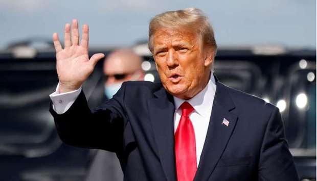 Donald Trump waves as he arrives at Palm Beach International Airport in West Palm Beach, Florida on January 20, 2021. REUTERS