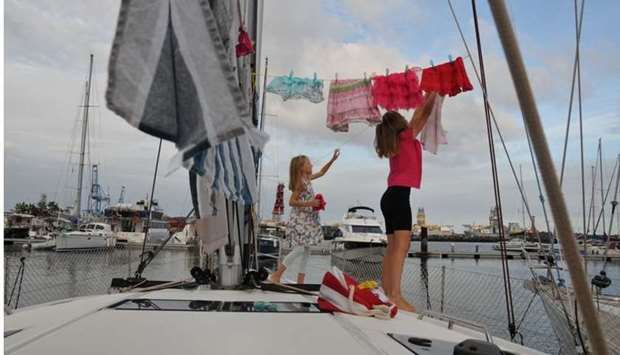 Katalin Bosze and Boroka Bosze hang clothes to dry on the sailing boat 'Teatime' in Las Palmas, Spain, October 5, 2020