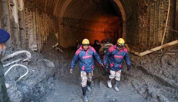 Members of a rescue team work inside a tunnel after a part of a glacier broke away in Tapovan, in the northern state of Uttarakhand, India