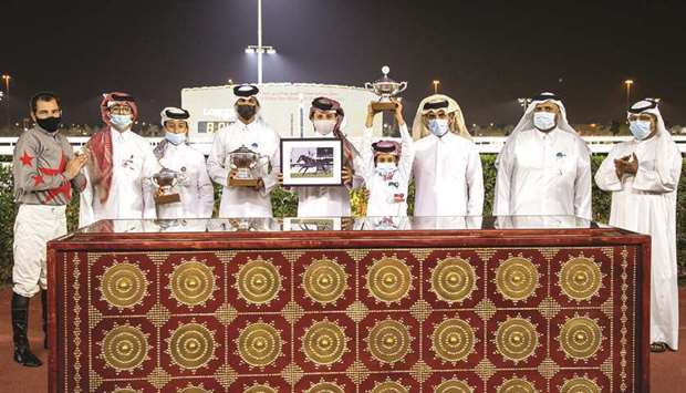 Qatar Racing and Equestrian Club (QREC) Acting CEO Badr Mohamed al-Darwish (third from right) with the winners of Al Wajba Cup after Zarandi won the 1,900m feature at Al Rayyan Park yesterday. PICTURES: Juhaim