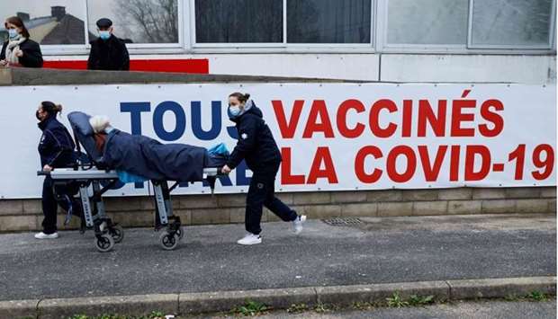 A woman is carried on a stretcher to the Covid-19 vaccination center at the South Ile-de-France Hospital Group (Groupe Hospitalier Sud Ile-de-France), in Melun, on the outskirts of Paris, on February 8