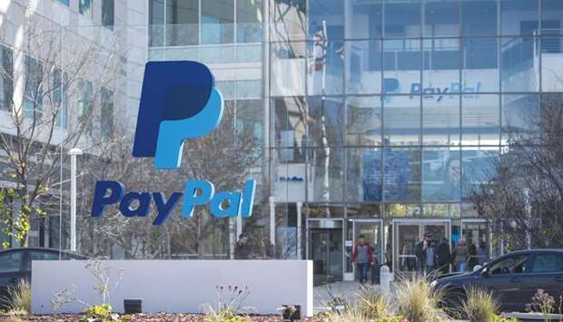 People exit PayPal Holdings headquarters in San Jose, California. PayPal is weighing a foray into stock trading and high-yield savings accounts as the firm pushes beyond its iconic checkout button.