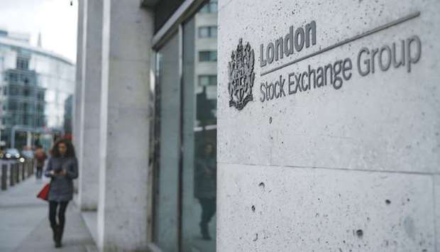 A pedestrian walks past the London Stock Exchange building. The FTSE 100 closed up 0.9% to 6,589.79 points yesterday.