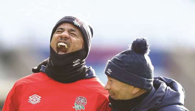 Englandu2019s wing Anthony Watson (L) and Englandu2019s coach Eddie Jones share a light moment during an England team training session at Twickenham Stadium, south west London, yesterday.