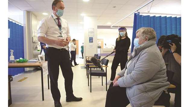 Chief Executive of the National Health Service in England, Sir Simon Stevens speaks to patients during a visit to a Covid-19 vaccination clinic at University Hospital Coventry in the Walsgrave on Sowe area of Coventry, West Midlands yesterday.
