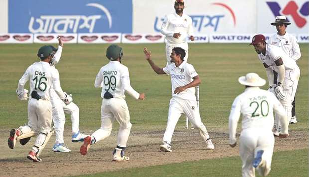 Bangladesh players celebrate the dismissal of West Indiesu2019 John Campbell (not pictured) during the third day of the second Test match in Dhaka yesterday. (AFP)