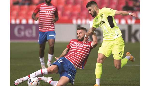 Granadau2019s Domingos Duarte (left) vies for the ball with Atletico Madridu2019s Yannick Carrasco in Granada, Spain, yesterday. (AFP)