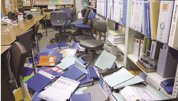 File folders are seen scattered on the floor of the Kyodo News bureau after a strong quake in Sendai, Miyagi Prefecture, Japan, yesterday.