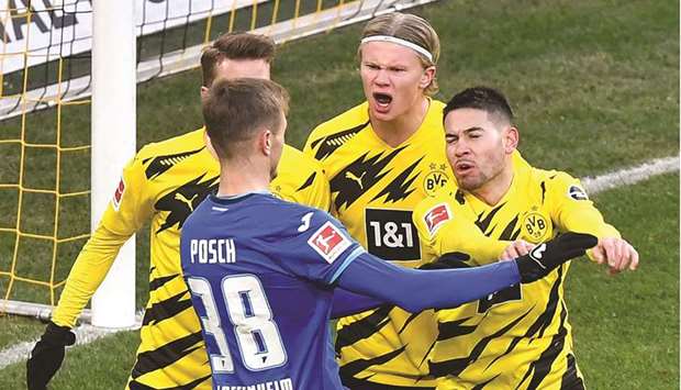 Hoffenheimu2019s Stefan Posch (second) argues with Dortmundu2019s Erling Braut Haaland (second right) during the Bundesliga match. (AFP)