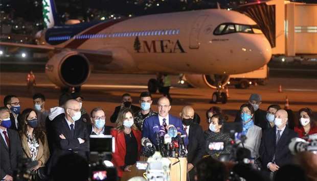 Lebanonu2019s caretaker health minister Hamad Hasan talks near the aircraft carrying the first batch of doses of the Pfizer/BioNTech vaccine against the coronavirus disease (Covid-19) at Beirut International Airport, yesterday.