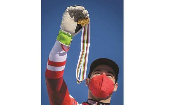 First-placed Austriau2019s Vincent Kriechmayr celebrates on the podium of the menu2019s downhill during the FIS Alpine World Ski Championships in Cortina du2019Ampezzo, Italian Alps. (AFP)