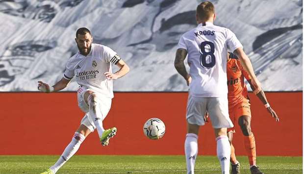 Real Madridu2019s French forward Karim Benzema (L) passes the ball to Toni Kroos during their Spanish league match at the Alfredo di Stefano stadium in Valdebebas yesterday.