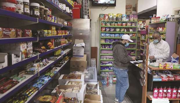 People wearing face masks are pictured inside a grocery shop in Beirut, Lebanon (file). Annual inflation was 84.9% in 2020, compared to just 2.9% a year earlier, according to data released by the governmentu2019s Central Administration of Statistics on Thursday.