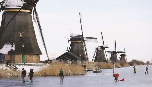 People ice skate during a cold snap yesterday across the Netherlands along the windmills in Kinderdijk.