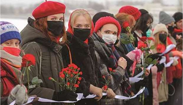 Participants form a human chain during a demonstration yesterday to support female political prisoners and to protest against police violence in Saint Petersburg.
