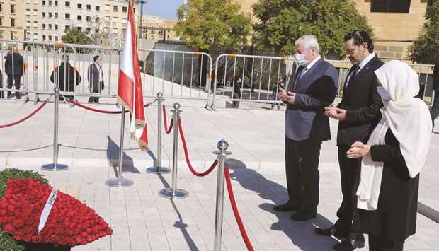 A handout picture provided by the Lebanese photo agency Dalati and Nohra shows Lebanonu2019s prime minister-designate, Saad Hariri, his aunt, MP Bahia Hariri (right), and uncle Shafiq, praying at the gravesite of his father, slain prime minister Rafik Hariri, in downtown Beirut, yesterday.