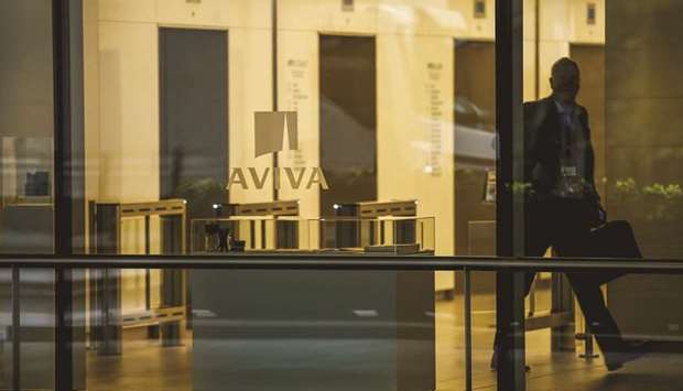 An office worker walks inside St Helenu2019s, the commercial skyscraper housing the headquarters of Aviva in London. Macif is seen as the most suitable buyer for Avivau2019s insurance operations in France, which could fetch more than u20ac3bn, because itu2019s a local player, the people said.