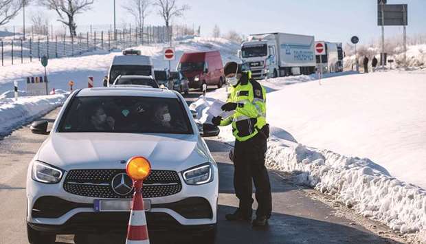 An officer of the Federal Police controls car drivers at the German-Czech border near Breitenau, eastern Germany. From Sunday, only German citizens and residents in the country are allowed to enter Germany from the Czech Republic and Austriau2019s Tyrol region, two zones where more infectious variants of coronavirus are widespread.
