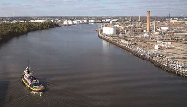 A tug boat turns in front of the PES Refinery on the Schuylkill River in Philadelphia, Pennsylvania (file). American refiners are processing the most crude since the economy ground to a halt in March in anticipation of a vaccine-driven boost in gasoline demand this summer.