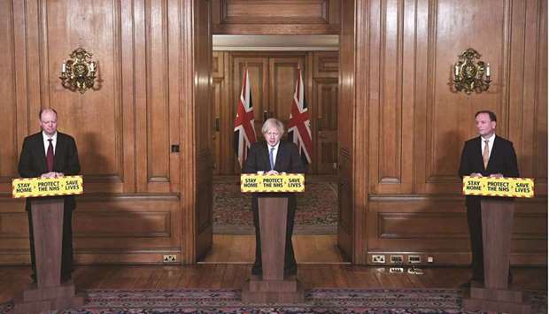 Britainu2019s Prime Minister Boris Johnson (centre), chief medical officer for England Chris Whitty (left) and chief executive of the National Health Service (NHS) Simon Stevens attend a virtual press conference inside 10 Downing Street in central London yesterday.