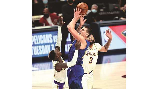 Denver Nuggets center Nikola Jokic (centre) attempts a shot as Los Angeles Lakers guard Dennis Schroder and forward Anthony Davis (right) defend in the second quarter at Ball Arena in Denver. (USA TODAY Sports)