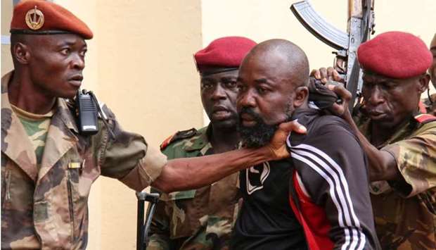 In this file photo taken on October 29, 2018 members of the armed forces arrest Central African MP Alfred Yekatom aka ,Rambo, (C), who represents the southern M'baiki district former militia leader, after he fired the gun at the parliament in Bangui.